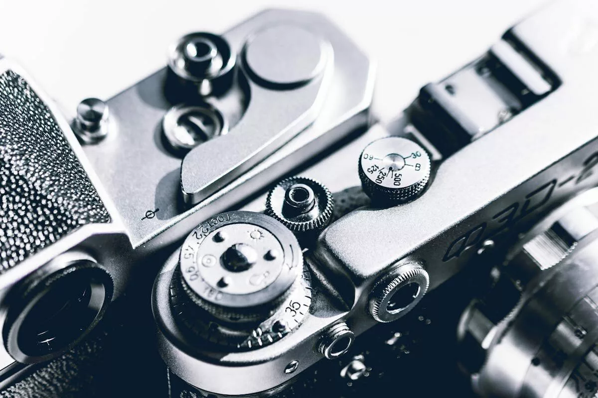 A detailed close-up of a vintage camera showing the mechanical dials and switches, highlighting classic design.