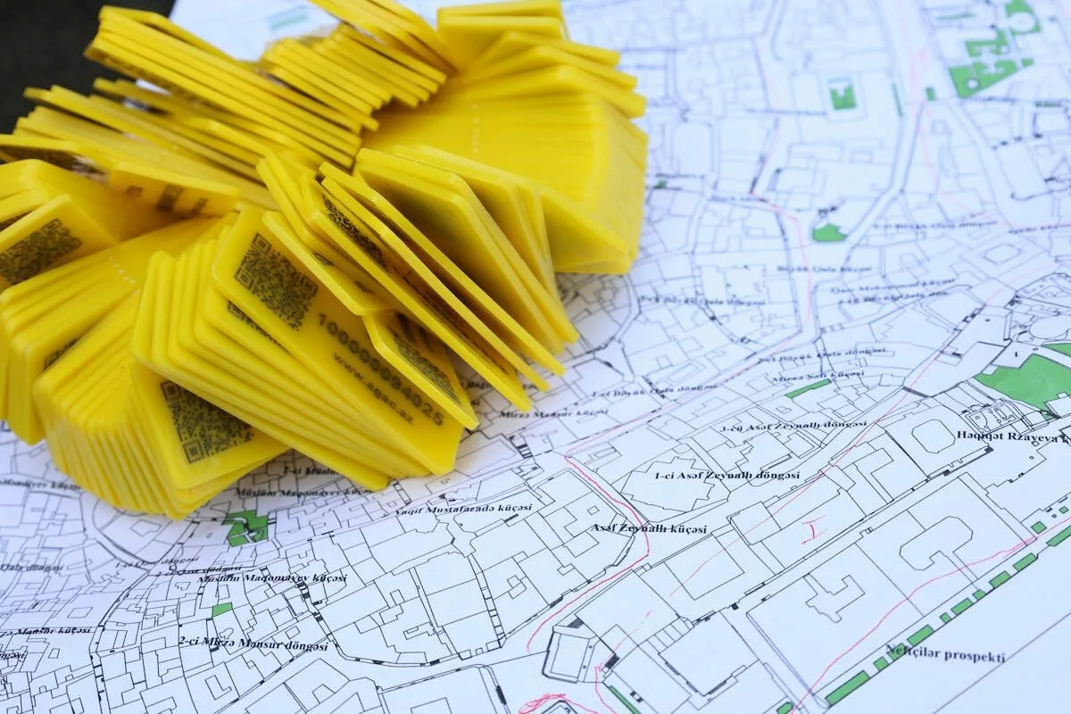 Stack of yellow QR code markers placed on a detailed map for location tracking and navigation.